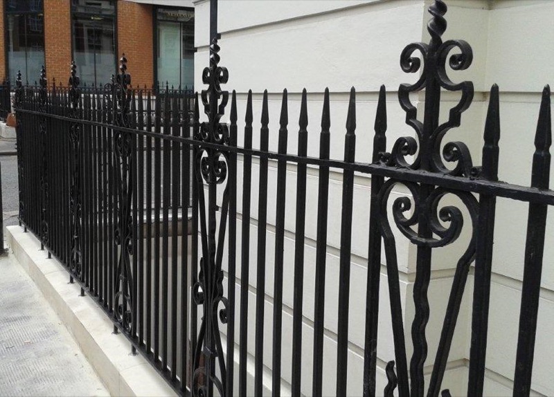 Ornate black iron railings on a London period property