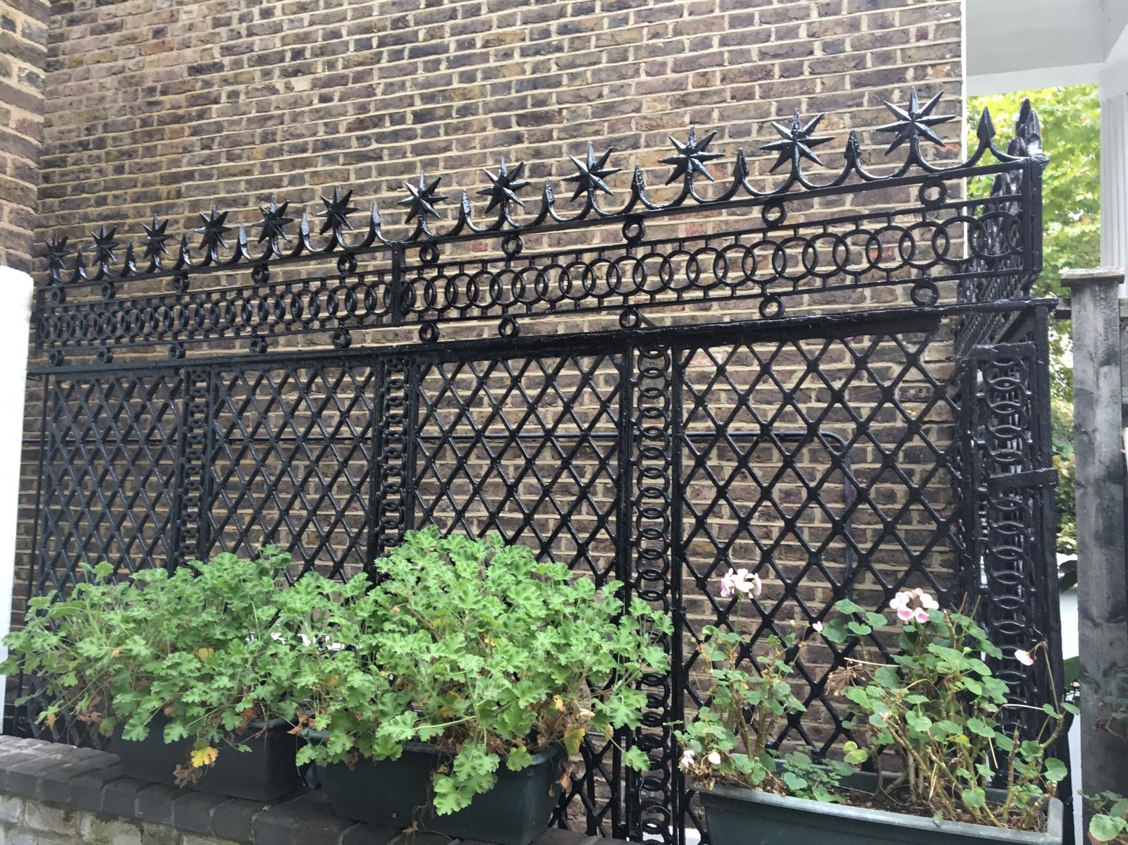 Ornate Victorian cast iron railings with diamond lattice panels